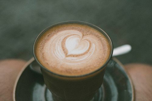 closeup photo of ceramic coffee mug with brown liquid inside